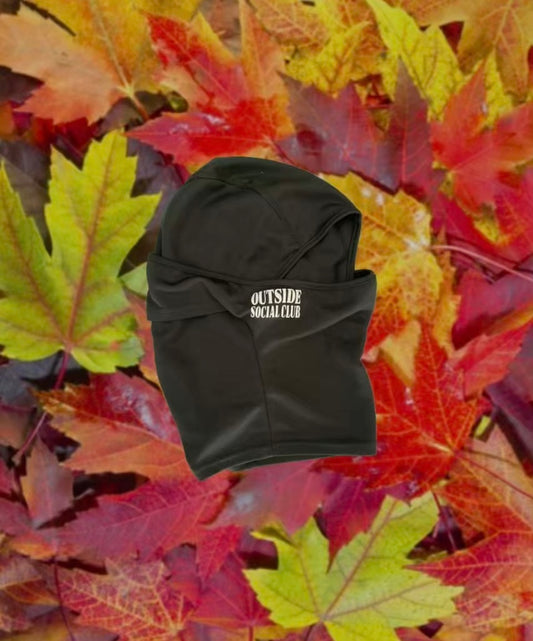 Black ski mask with 'Outside Social Club' text on a background of autumn leaves